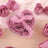 Pink rose soap flowers in a heart-shaped box with a ribbon.