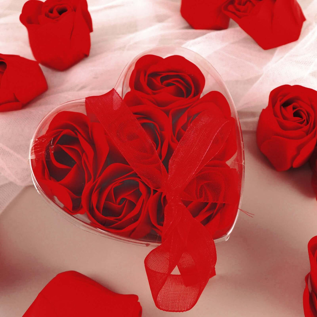 Heart-shaped box of red roses with a red ribbon.