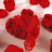 Heart-shaped box of red roses with a red ribbon.