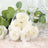 White rose soap flowers in a heart-shaped box with a ribbon.