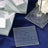 Engraved glass coasters with "LOVE" design for wedding favors.