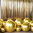 Gold balloons in various sizes against a shiny gold backdrop.