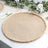 Natural woven round placemat with braided edges on a table setting.