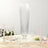 Elegant tall glass vase with ribbed design, perfect for floral arrangements.