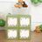 Decorative storage boxes with green design and floral accents in a playful setting.