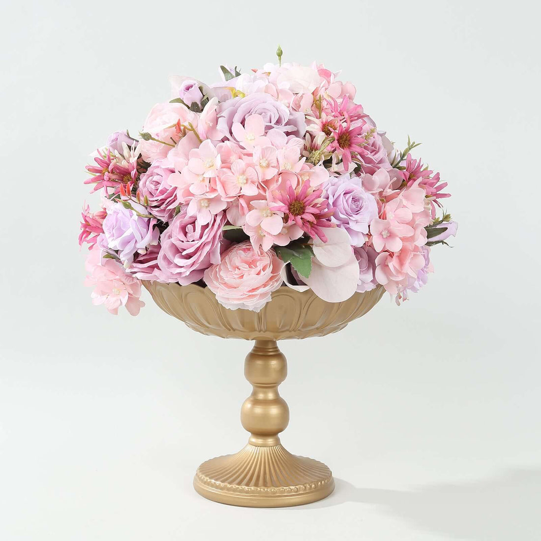 Pink floral arrangement in a gold pedestal vase