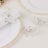 Silver butterfly napkin rings on elegant table setting.