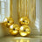 Shiny gold decorative balls in a bright, stylish interior setting.
