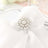 Elegant pearl napkin holder on a white table setting.