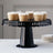 Black cake stand with cupcakes on a plain background.