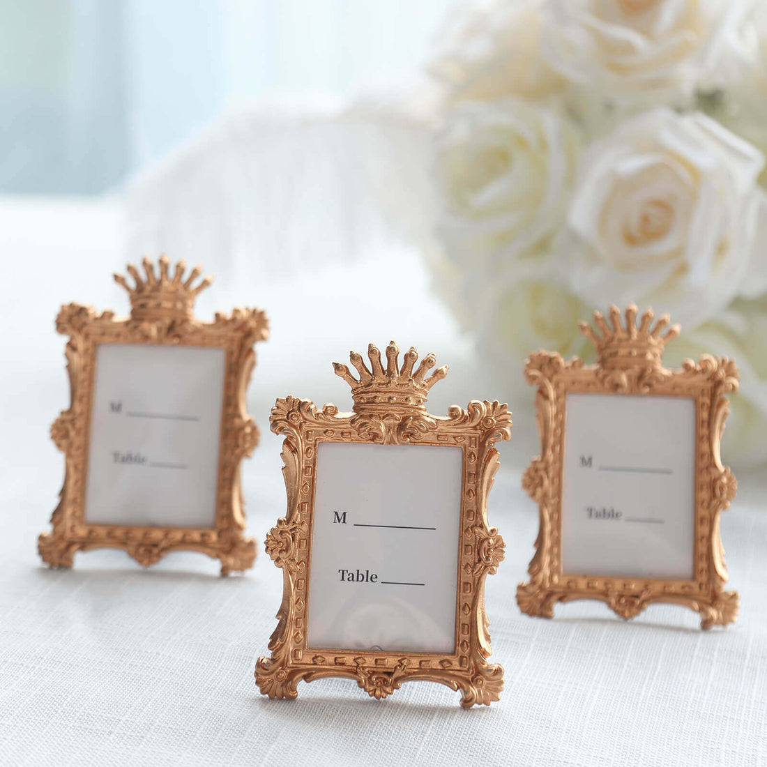 Ornate gold table name card holders with blank labels for events