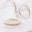 Elegant pearl and crystal hoop earrings on a soft fabric backdrop.