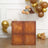 Wooden storage cube with plush teddy bears on top in a festive setting.