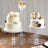 Elegant cake stands displaying decorated cakes and cupcakes on a wooden table.