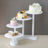 Tiered cake stand with various decorated cakes and cupcakes.