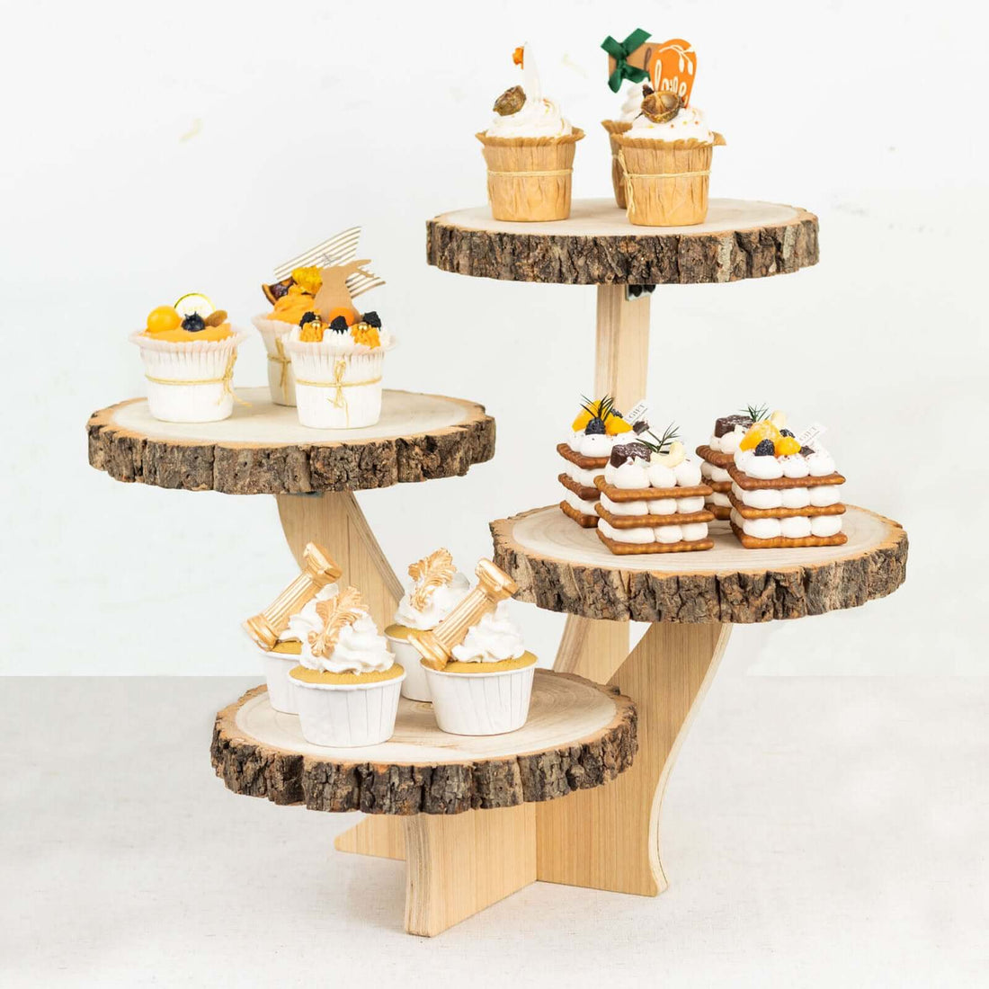 Tiered wooden display stand with assorted decorative cupcakes.
