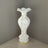 Elegant white vase with gold accents and textured design.