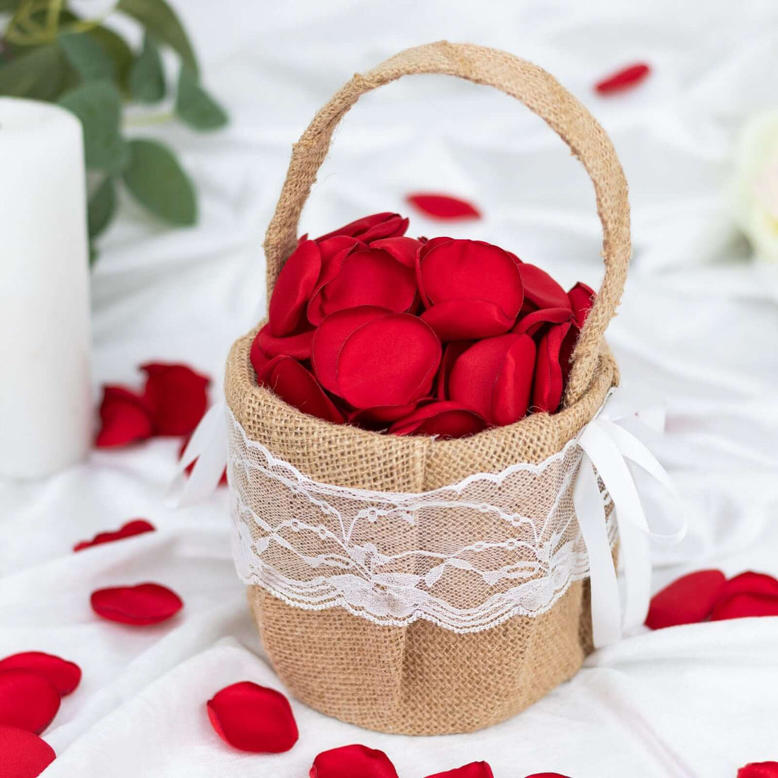 Red rose petals in a rustic burlap basket with lace trim.