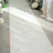 Elegant ivory satin runner on a soft carpet, adorned with floral arrangements.