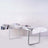 Silver tablecloth draped over a table set for dining with plates and glasses.