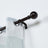 Brown curtain rod with decorative finial and sheer striped curtains