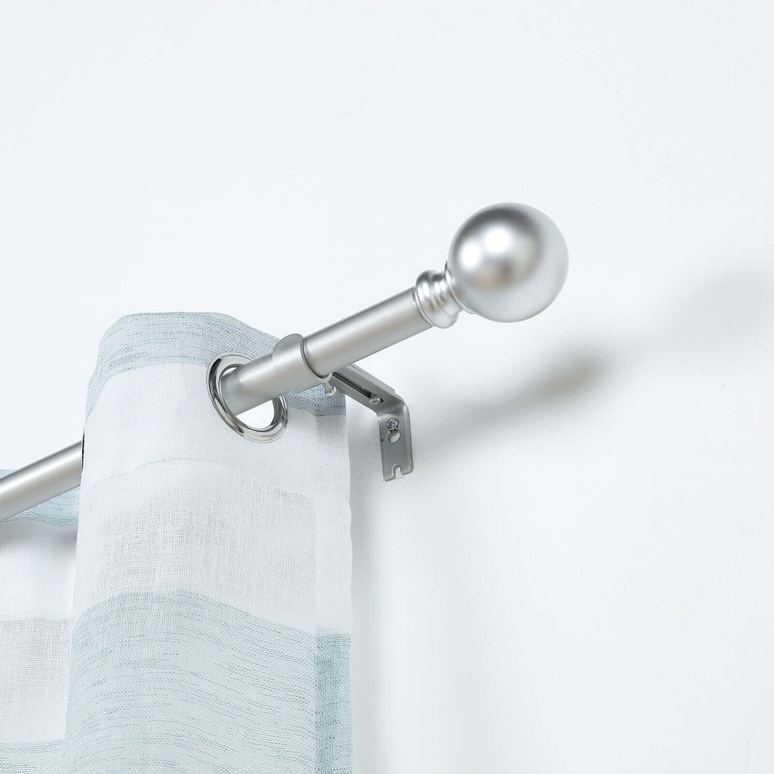 Silver curtain rod with a light fabric panel