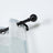 Curtain rod with striped curtain, featuring black hardware and rings.