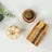Gold party cups stacked with decorative floral accents on a white background.