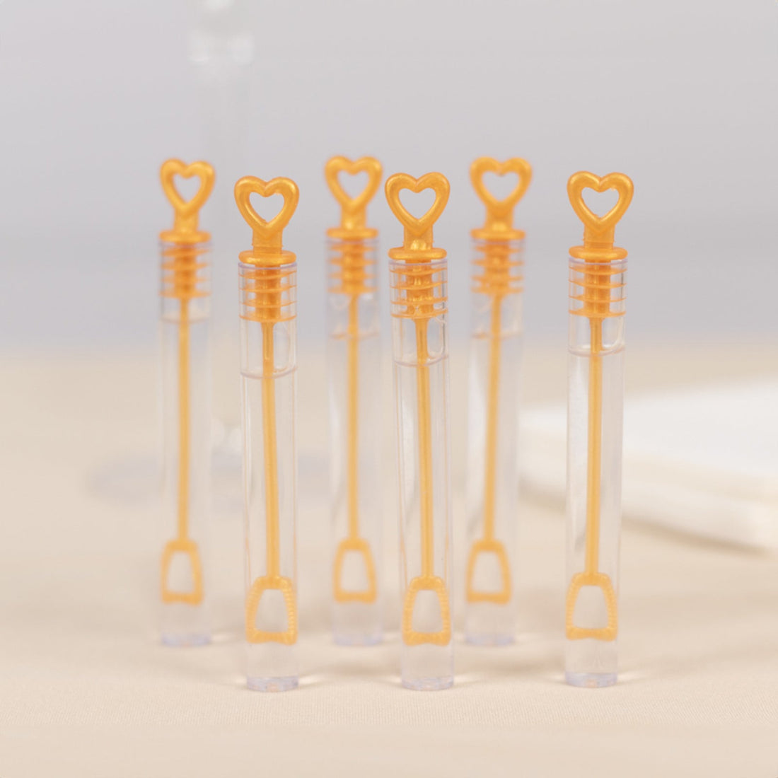 Heart-shaped bubble wands in clear tubes, perfect for parties and celebrations.