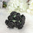 Black rose hair accessory on a soft textured background.
