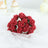 Red rose bouquet arrangement on soft fabric.