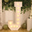 Illuminated decorative letter "J" with warm lights in a festive setting.