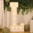 Illuminated marquee letter "L" with bulbs on a decorative backdrop.