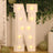 Light-up decorative letter "N" with warm bulbs against a festive backdrop.