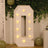 Illuminated marquee letter "Q" with warm lights against a decorative backdrop.