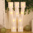 Illuminated letter "W" marquee light with bulbs against greenery background.