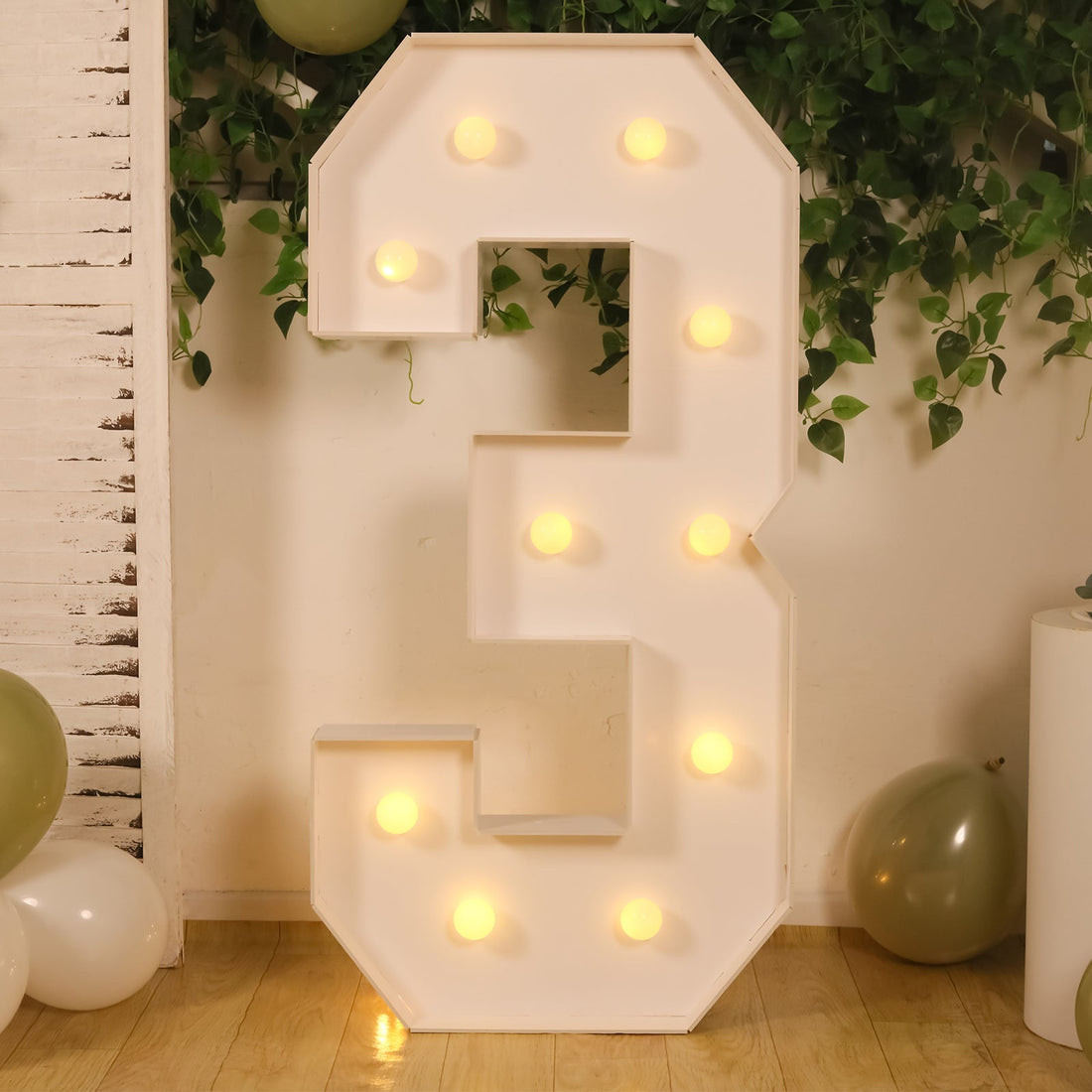 Large illuminated number 3 decoration with bulbs, perfect for parties or events.