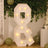 Light-up "&" marquee sign in a decorated party setting.