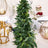 Greenery table runner with decorative elements for elegant dining setup.