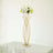 Gold flower vase with white flowers on a minimalist table