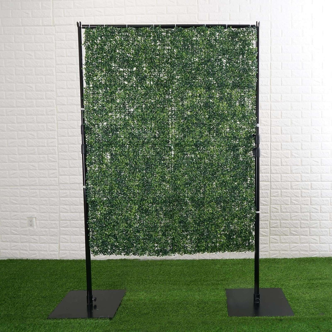 Artificial green hedge panel on a metal frame for decoration or privacy.