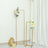 Gold flower stands with floral arrangements on a plain background.