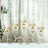 Elegant gold candle holder with glass vases for pillar candles.