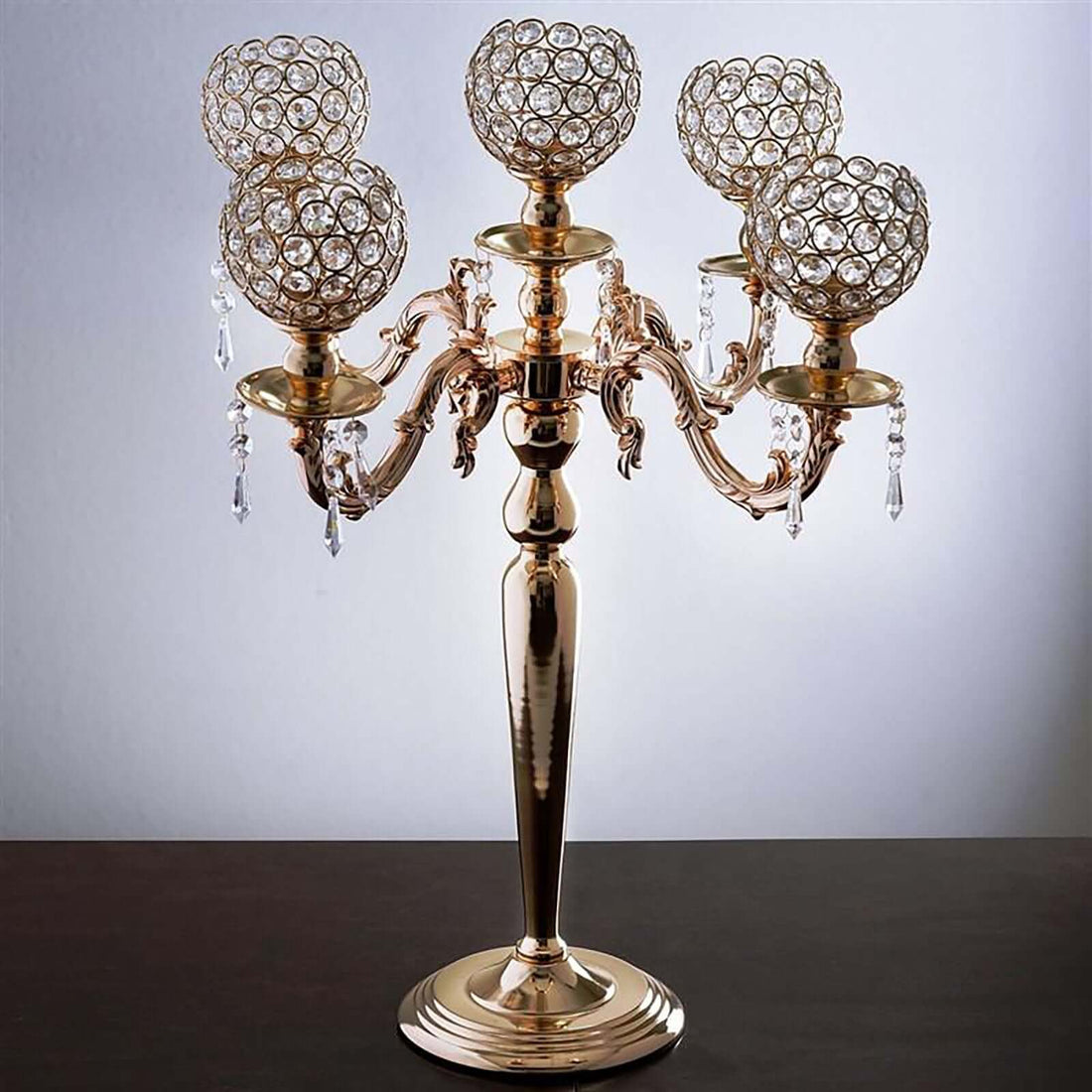Elegant gold candelabra with crystal globes and decorative details.