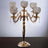 Elegant gold candelabra with crystal globes and decorative details.
