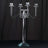 Elegant crystal candelabra with four arms and diamond-shaped holders.