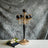 Elegant black and gold candelabra with crystal accents on a textured backdrop.