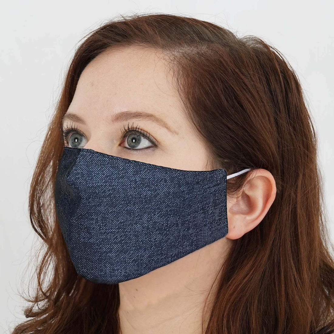 Woman wearing a dark denim face mask.