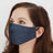 Woman wearing a dark denim face mask.