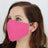 Woman wearing a pink fabric face mask.